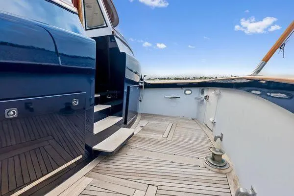 Chanticleer Yacht Photos Pics 1973 Burger 310C yacht deck with wooden flooring and blue sky background.
