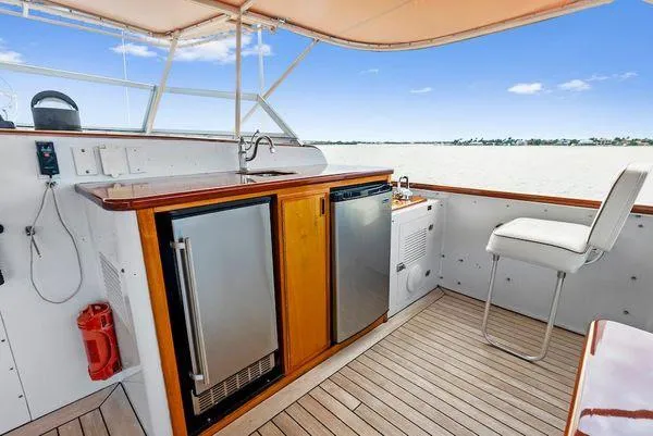 Chanticleer Yacht Photos Pics 1973 Burger 310C yacht deck with seating, mini fridge, and ocean view.