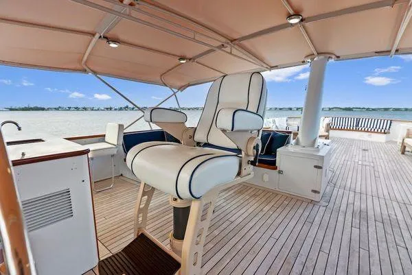 Chanticleer Yacht Photos Pics Luxury yacht deck with captain's chair, wood flooring, and ocean view, Burger 310C, 1973 model.