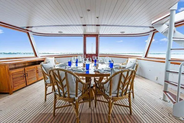Chanticleer Yacht Photos Pics Luxurious dining area on 1973 Burger 310C yacht with ocean view.