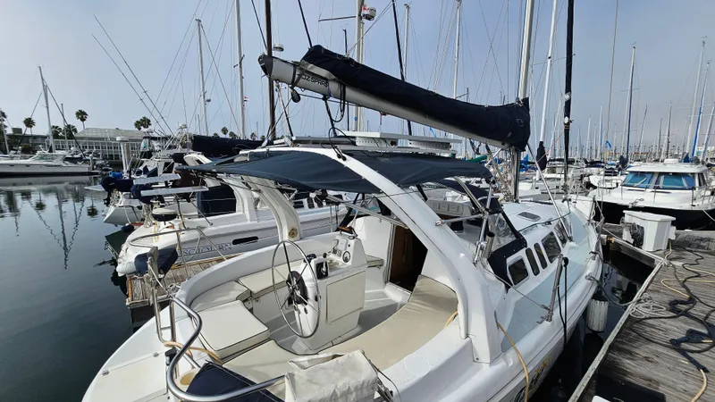  Yacht Photos Pics 1998 Hunter 340 Sloop sailboat docked in a marina, surrounded by other boats.