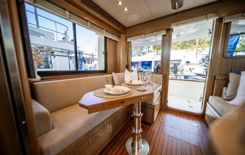 Nordhavn 41 Yacht Photos Pics Luxurious interior of 2022 Nordhavn 41 yacht with elegant seating and dining area.