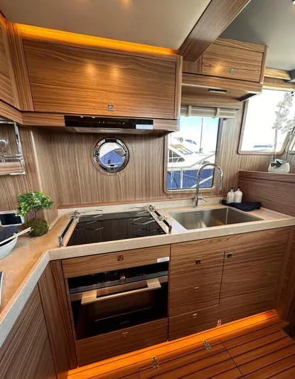 Nordhavn 41 Yacht Photos Pics Modern kitchen in 2022 Nordhavn 41 yacht with wood cabinetry and stainless steel appliances.