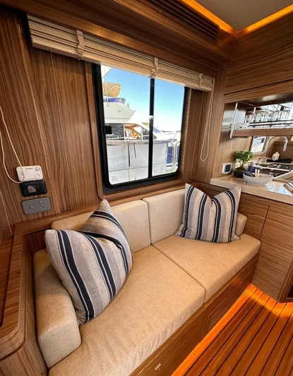 Nordhavn 41 Yacht Photos Pics Interior of 2022 Nordhavn 41 yacht with cozy seating and striped pillows.