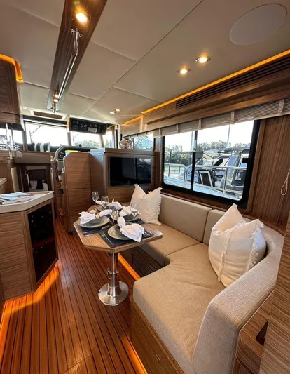 Nordhavn 41 Yacht Photos Pics Luxurious interior of a 2022 Nordhavn 41 yacht with elegant wood finishes and cozy seating.