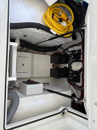 My Angel Yacht Photos Pics Engine compartment of 2023 Beneteau Gran Turismo 32 with wiring and hoses visible.