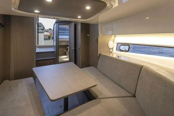 My Angel Yacht Photos Pics Interior of 2023 Beneteau Gran Turismo 32 yacht, featuring a cozy dining area with modern furnishings.