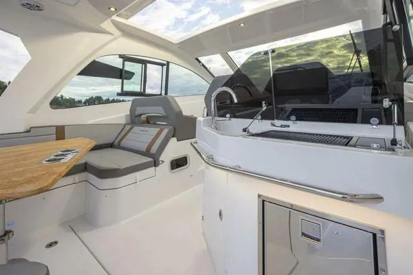 My Angel Yacht Photos Pics 2023 Beneteau Gran Turismo 32 interior with seating and kitchenette, featuring modern design elements.