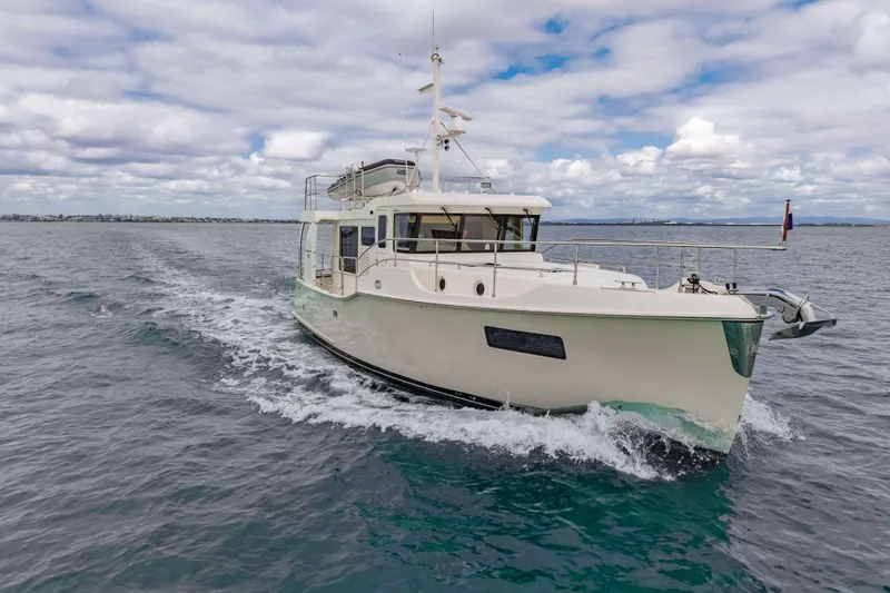 Nordhavn 41 Yacht Photos Pics 2023 Nordhavn 41 yacht cruising on open water under cloudy skies.