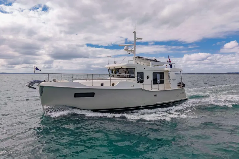 Nordhavn 41 Yacht Photos Pics 2023 Nordhavn 41 yacht cruising on open water under a cloudy sky.