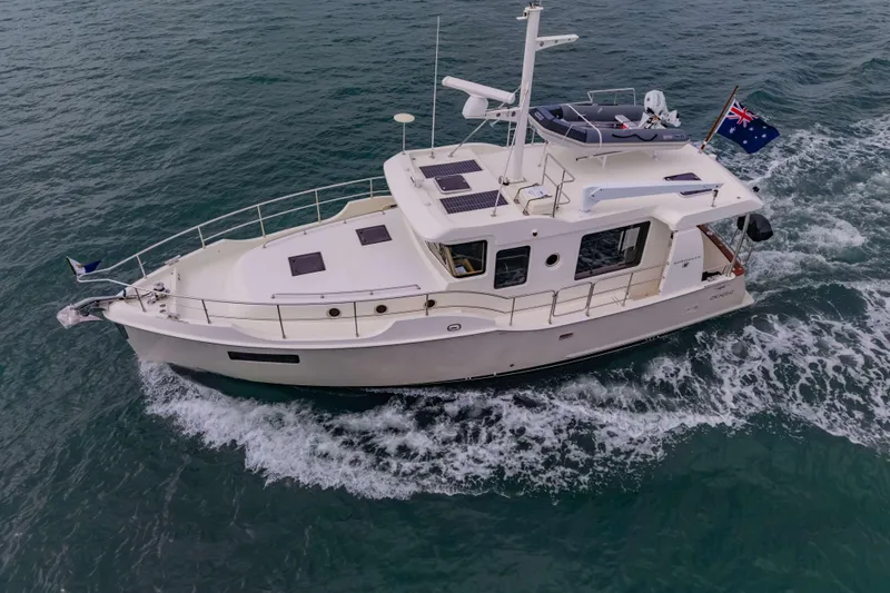 Nordhavn 41 Yacht Photos Pics 2023 Nordhavn 41 yacht cruising on open water, featuring sleek design and Australian flag.