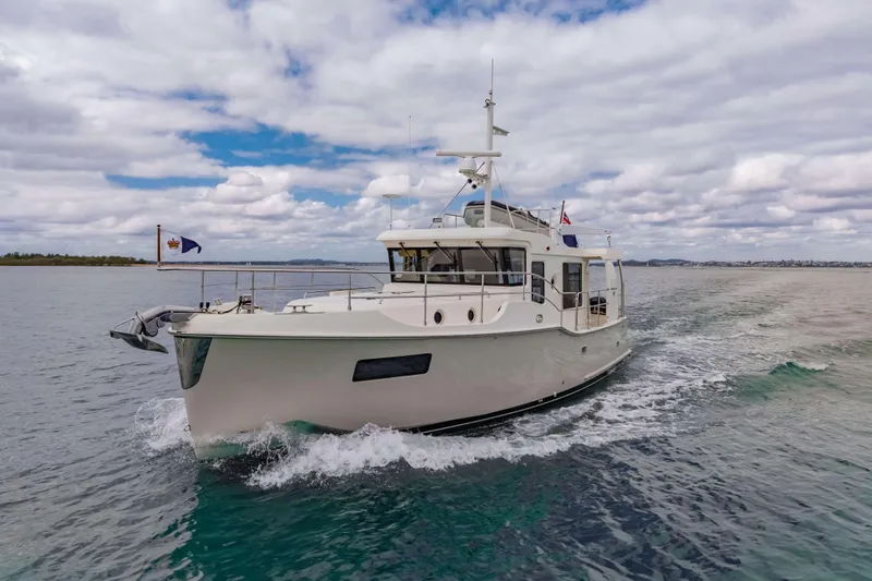 Nordhavn 41 Yacht Photos Pics 2023 Nordhavn 41 yacht cruising on open water under a cloudy sky.