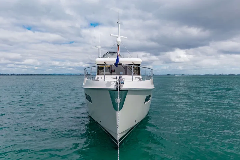 Nordhavn 41 Yacht Photos Pics 2023 Nordhavn 41 yacht anchored on calm sea under cloudy sky.