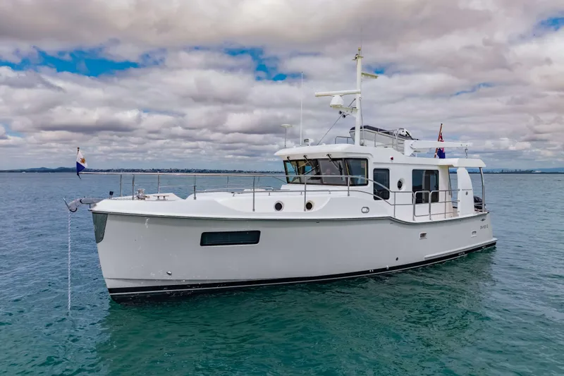 Nordhavn 41 Yacht Photos Pics 2023 Nordhavn 41 yacht on calm sea under cloudy sky.