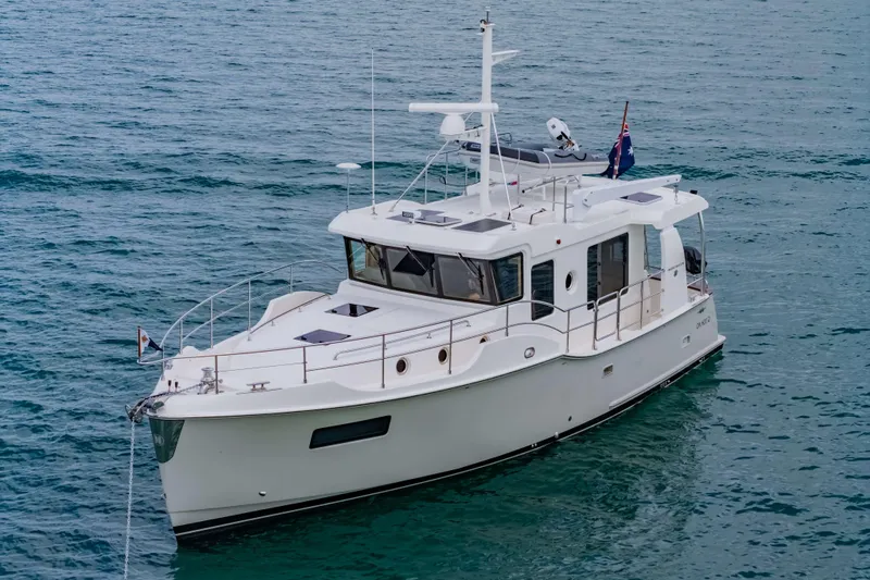 Nordhavn 41 Yacht Photos Pics 2023 Nordhavn 41 yacht on calm blue water, featuring sleek design and modern amenities.