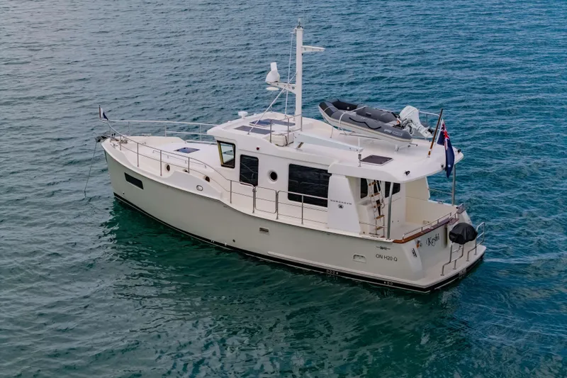 Nordhavn 41 Yacht Photos Pics 2023 Nordhavn 41 yacht on calm blue water, featuring sleek design and modern amenities.