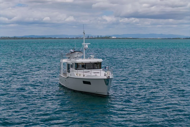 Nordhavn 41 Yacht Photos Pics 2023 Nordhavn 41 yacht cruising on calm blue waters under a cloudy sky.