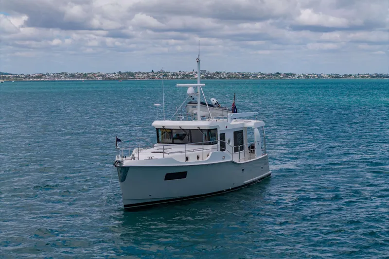 Nordhavn 41 Yacht Photos Pics 2023 Nordhavn 41 yacht cruising on calm blue waters under a cloudy sky.