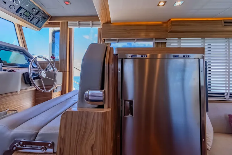 Nordhavn 41 Yacht Photos Pics Luxurious interior of 2023 Nordhavn 41 yacht with modern helm and stainless steel fridge.