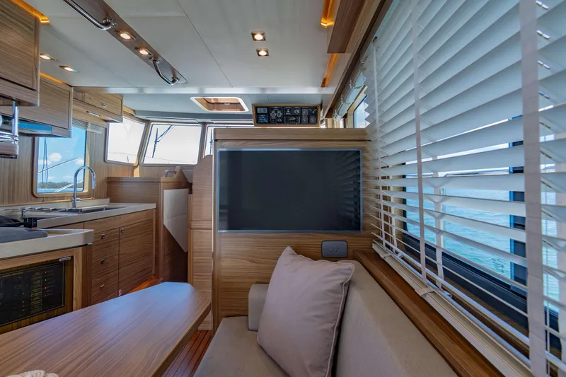 Nordhavn 41 Yacht Photos Pics Luxurious interior of 2023 Nordhavn 41 yacht with modern kitchen and seating area.