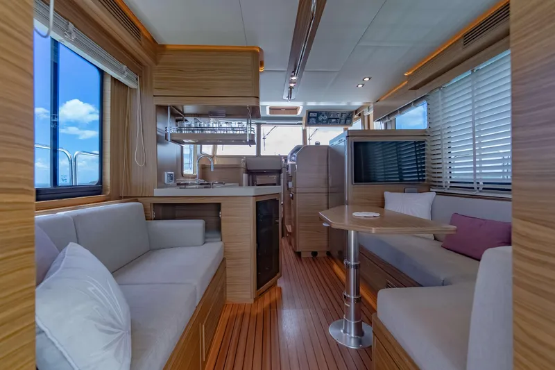 Nordhavn 41 Yacht Photos Pics Luxurious interior of 2023 Nordhavn 41 yacht with modern wood finishes and comfortable seating.