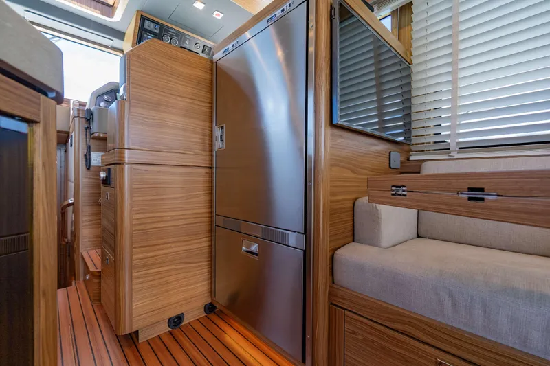 Nordhavn 41 Yacht Photos Pics Interior of 2023 Nordhavn 41 yacht with wood paneling and modern appliances.