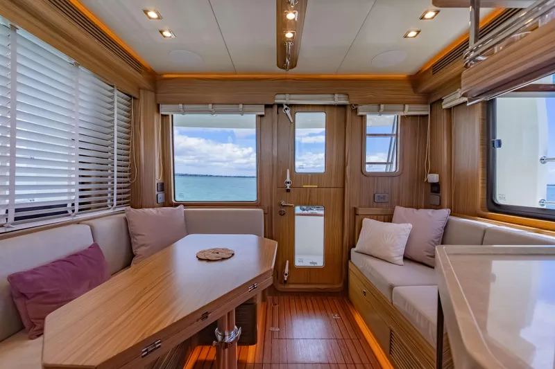Nordhavn 41 Yacht Photos Pics Luxurious interior of 2023 Nordhavn 41 yacht with wood finish and ocean view.