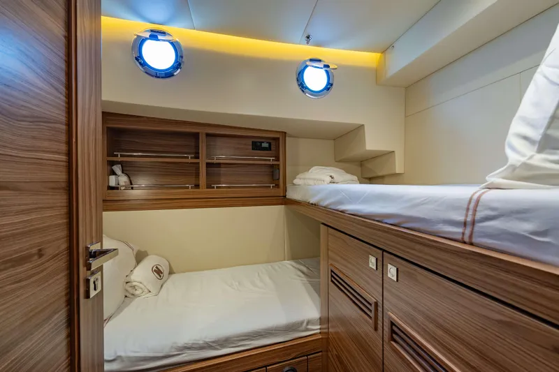Nordhavn 41 Yacht Photos Pics Cozy cabin interior of 2023 Nordhavn 41 yacht with wooden bunk beds and portholes.