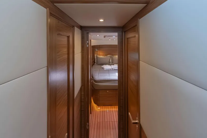 Nordhavn 41 Yacht Photos Pics Luxurious interior of 2023 Nordhavn 41 yacht, featuring a cozy bedroom and elegant wood finishes.