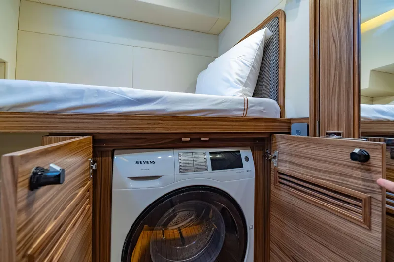 Nordhavn 41 Yacht Photos Pics 2023 Nordhavn 41 interior with Siemens washer under a wooden bunk bed.