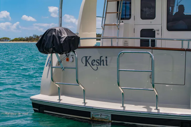 Nordhavn 41 Yacht Photos Pics 2023 Nordhavn 41 yacht "Keshi" on serene blue water, rear view.