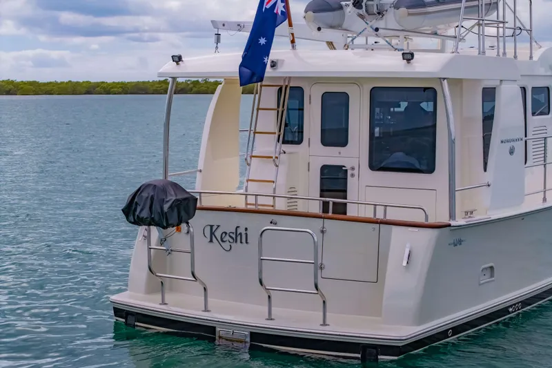 Nordhavn 41 Yacht Photos Pics 2023 Nordhavn 41 yacht "Keshi" with Australian flag, docked on calm waters.