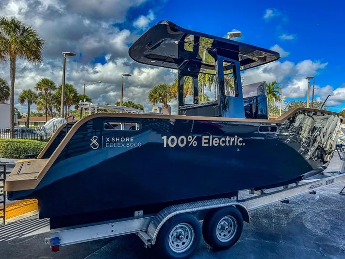  Yacht Photos Pics 2023 X Shore Eelex 8000 electric boat on trailer under blue sky.