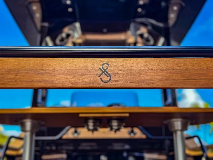  Yacht Photos Pics Close-up of 2023 X Shore Eelex 8000 boat's wooden detail with logo.