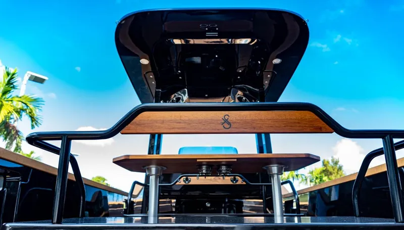  Yacht Photos Pics 2023 X Shore Eelex 8000 electric boat, rear view with wooden details and blue sky background.