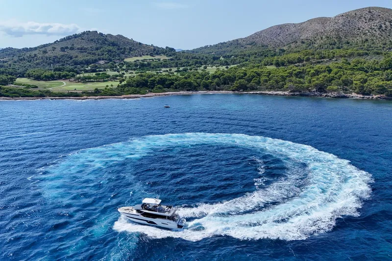  Yacht Photos Pics Luxury yacht Prestige X60 cruising in scenic coastal waters, 2023 model.