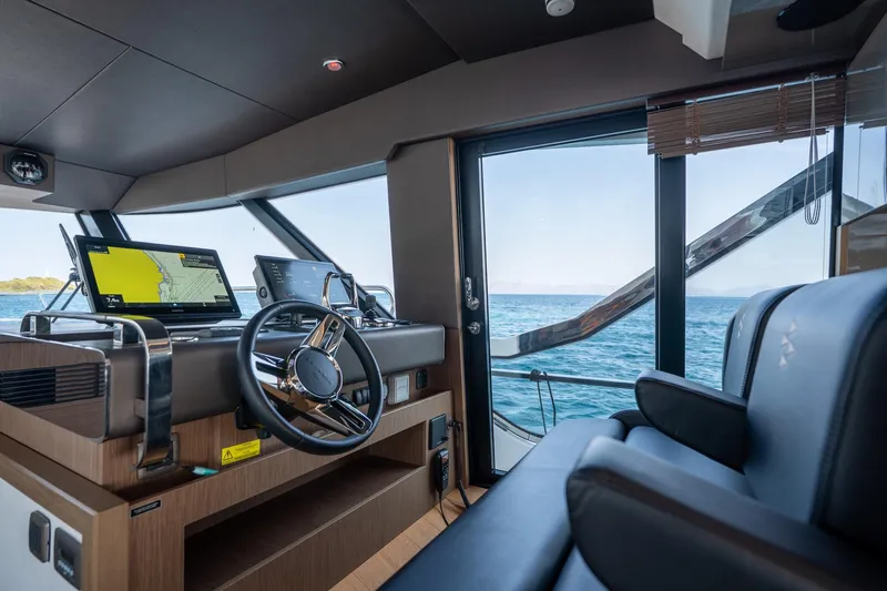  Yacht Photos Pics Interior of 2023 Prestige X60 yacht cockpit with navigation screens and ocean view.