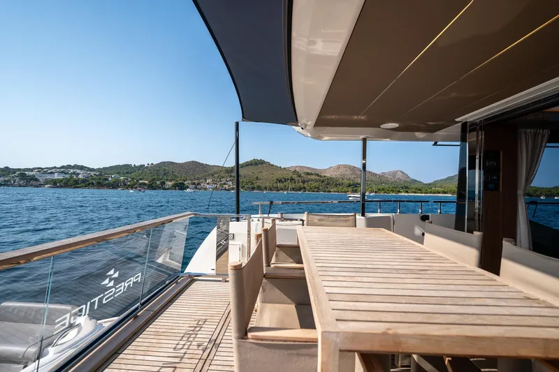  Yacht Photos Pics Luxury yacht Prestige X60 2023 with elegant deck dining area and scenic ocean view.