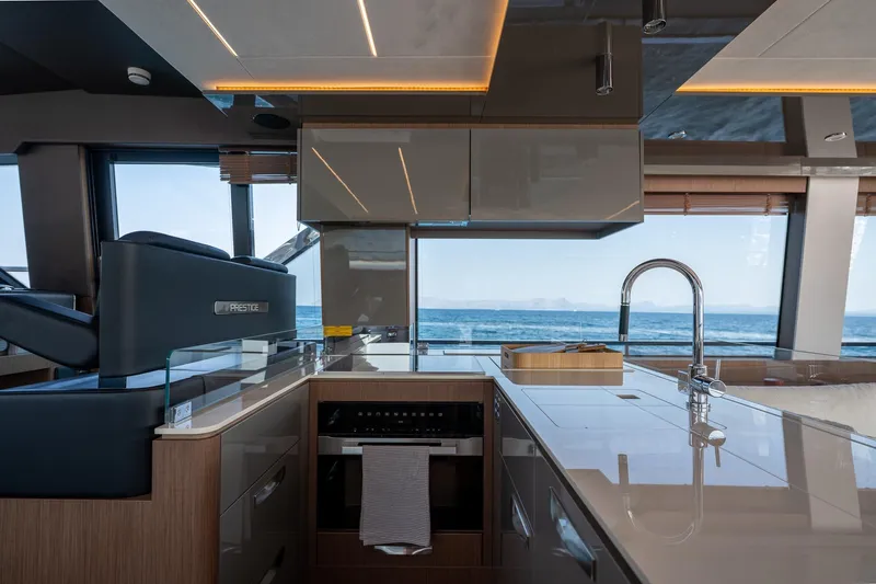  Yacht Photos Pics Luxurious 2023 Prestige X60 yacht interior with modern kitchen and ocean view.