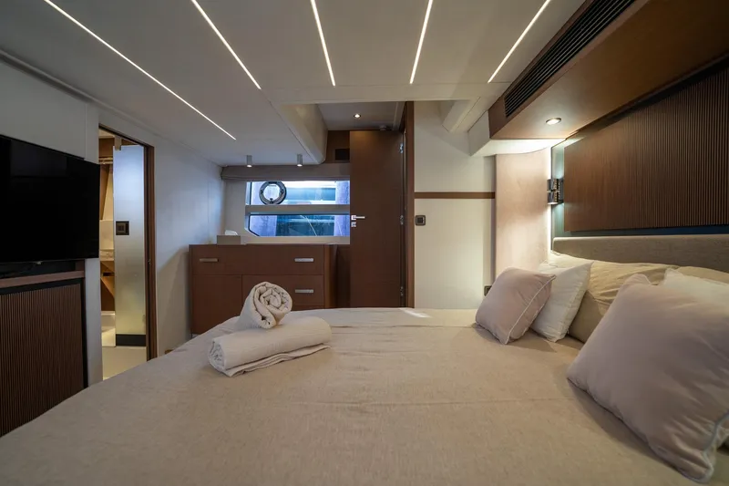  Yacht Photos Pics Luxurious bedroom interior of 2023 Prestige X60 yacht with modern design and cozy bedding.
