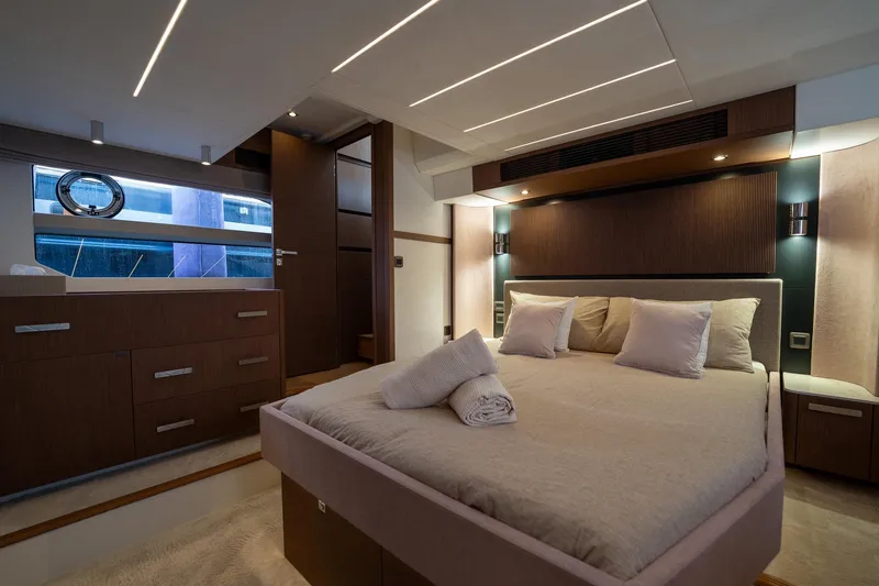  Yacht Photos Pics Luxurious bedroom interior of 2023 Prestige X60 yacht with modern design and ambient lighting.