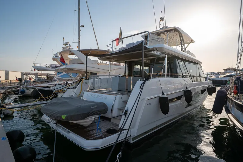  Yacht Photos Pics Luxury 2023 Prestige X60 yacht docked at marina during sunset.
