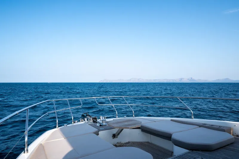  Yacht Photos Pics Luxurious 2023 Prestige X60 yacht deck with ocean view and distant mountains.