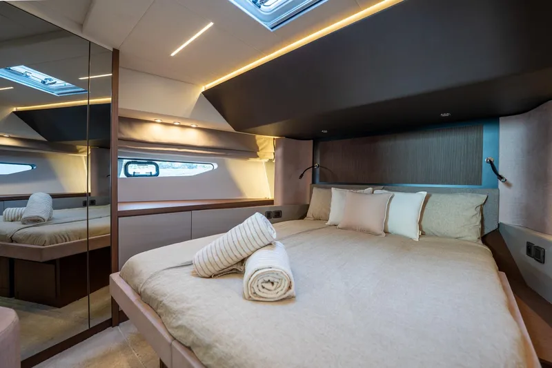  Yacht Photos Pics Luxurious 2023 Prestige X60 yacht bedroom with elegant bedding and modern lighting.