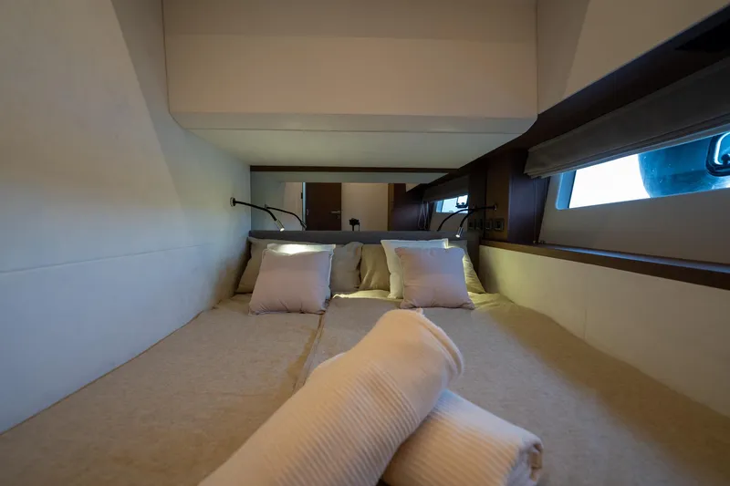  Yacht Photos Pics Luxurious cabin interior of 2023 Prestige X60 yacht with cozy bedding and modern design.