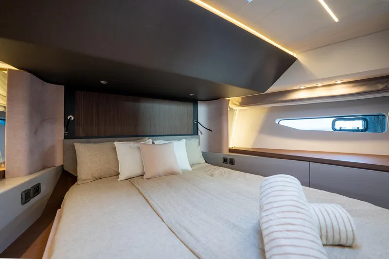  Yacht Photos Pics Luxurious bedroom interior of 2023 Prestige X60 yacht with modern design and ambient lighting.