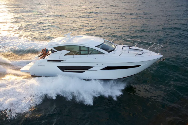  Yacht Photos Pics 2026 Cruisers Yachts 46 Cantius cruising on open water at sunset.