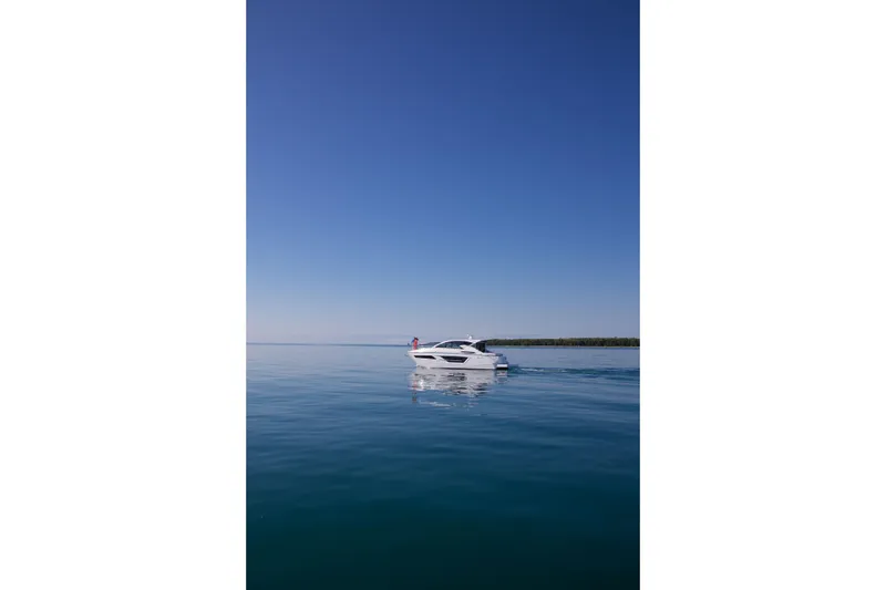  Yacht Photos Pics 2026 Cruisers Yachts 46 Cantius on calm blue water under clear sky.