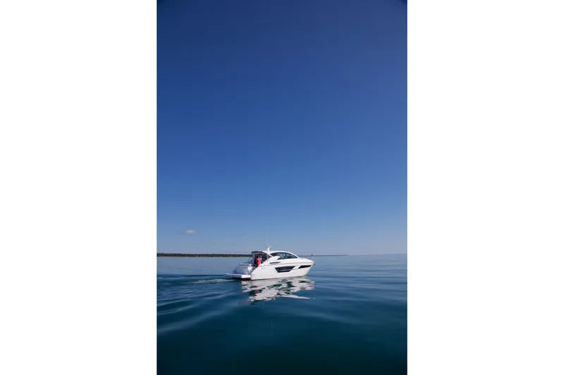  Yacht Photos Pics 2026 Cruisers Yachts 46 Cantius on calm blue water under clear sky.