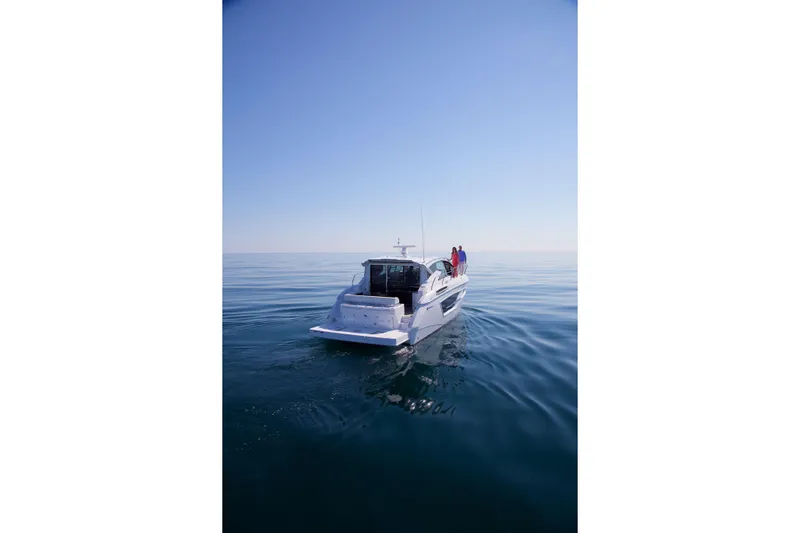  Yacht Photos Pics 2026 Cruisers Yachts 46 Cantius on calm ocean waters under clear blue sky.